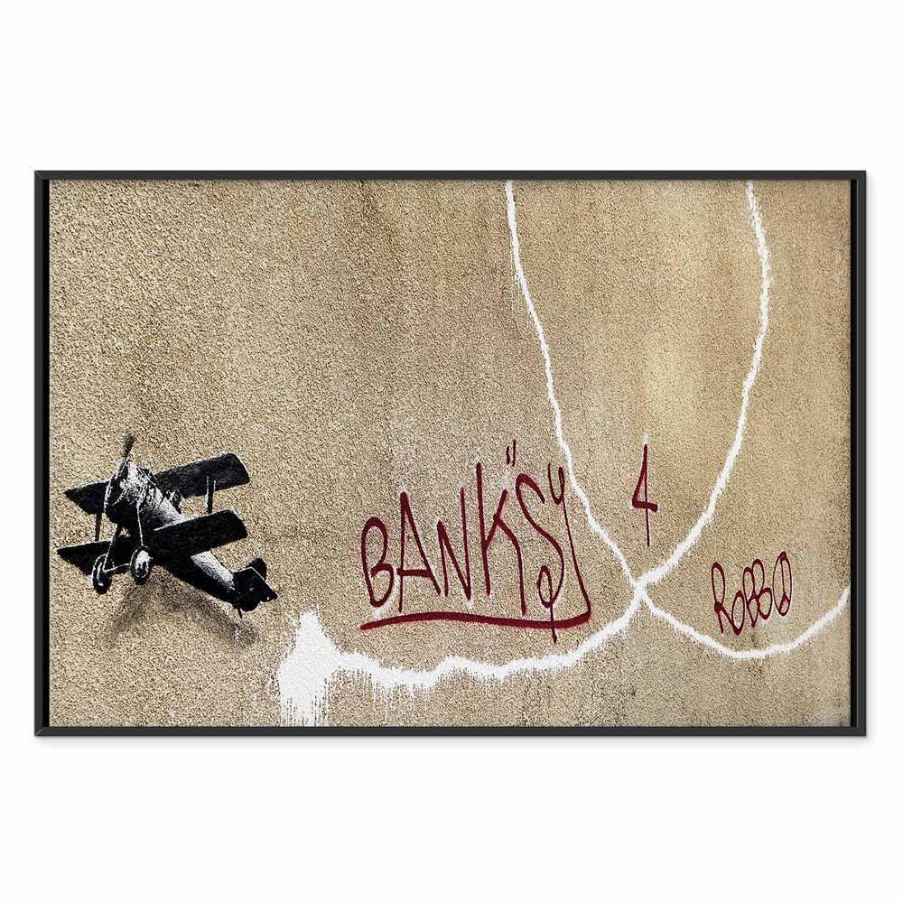 Leinwandbild - Banksy's Plane (1-part) - Red Graffiti Text on Mural Background