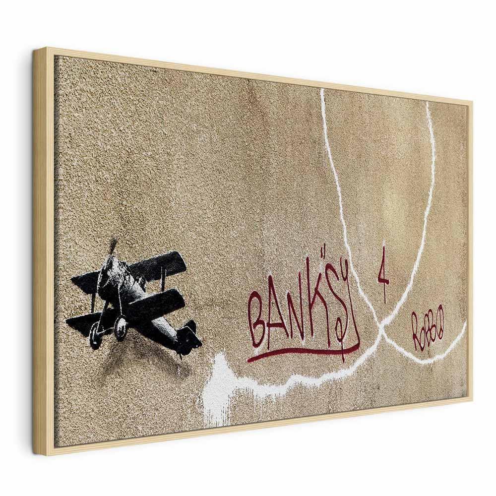 Leinwandbild - Banksy's Plane (1-part) - Red Graffiti Text on Mural Background