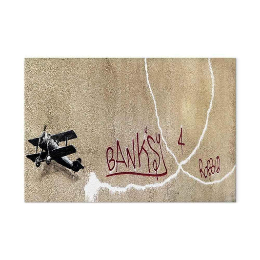 Leinwandbild - Banksy's Plane (1-part) - Red Graffiti Text on Mural Background