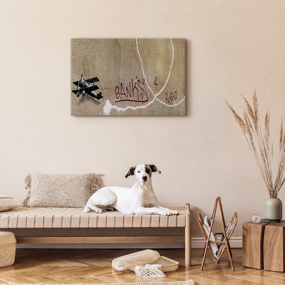 Leinwandbild - Banksy's Plane (1-part) - Red Graffiti Text on Mural Background