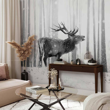 Black and white deer in snowy forest wall mural in modern living room.