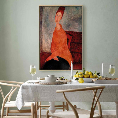 Canvas art of Jeanne Hebuterne in a yellow sweater on a framed wall.