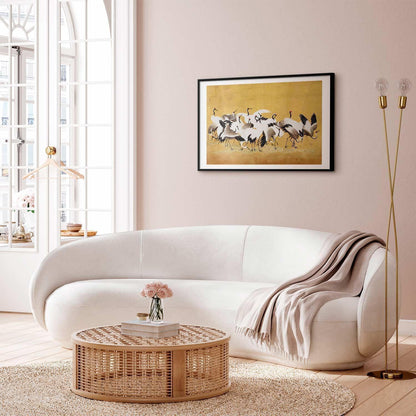 Poster featuring Japanese cranes on a golden background, inspired by Ishida Yūtei's painting, elegantly displayed in a living room setting.