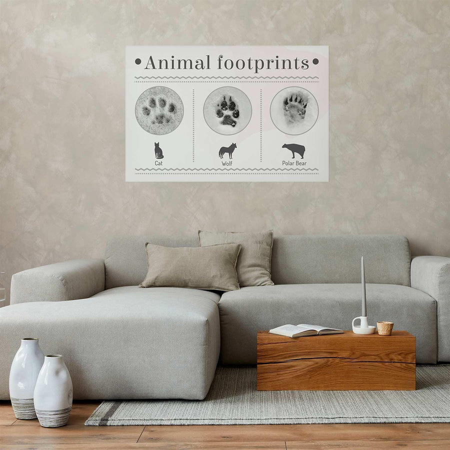 Animal paw prints poster on beige wall above grey sofa.