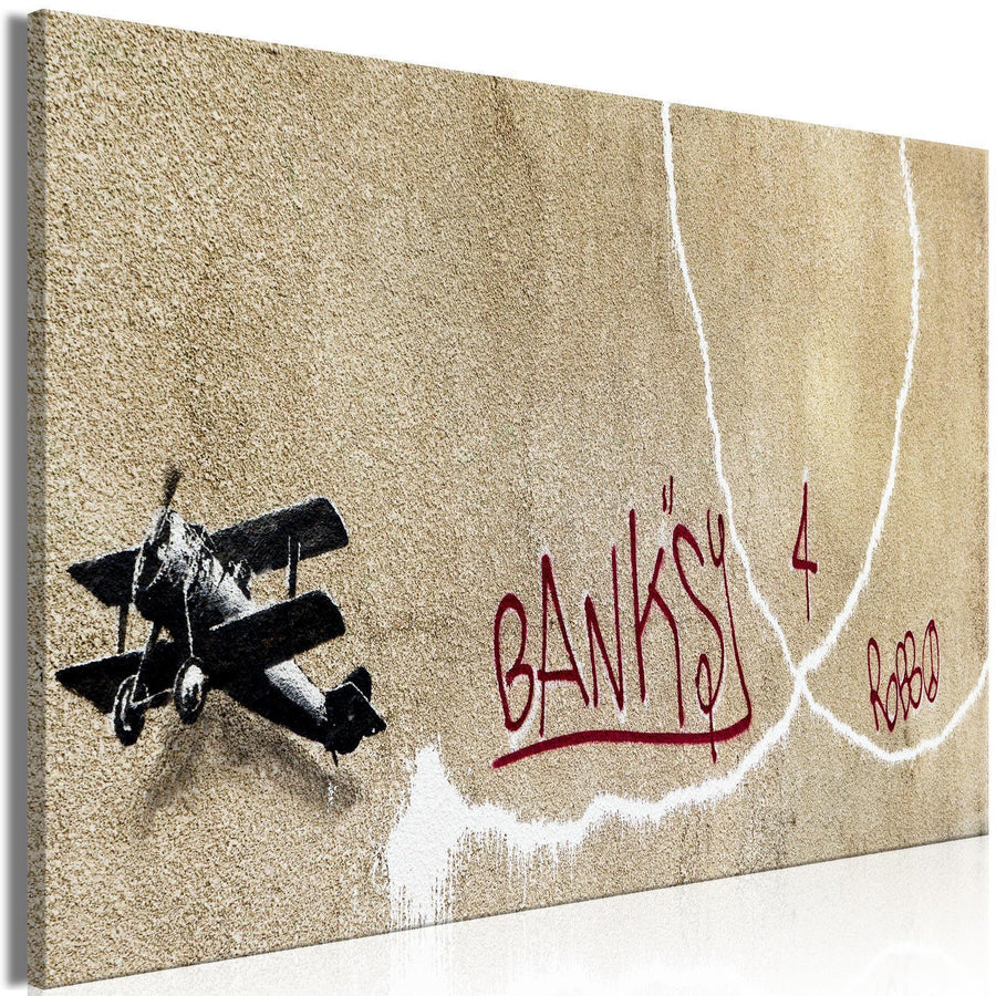 Leinwandbild - Banksy's Plane (1-part) - Red Graffiti Text on Mural Background Artgeist