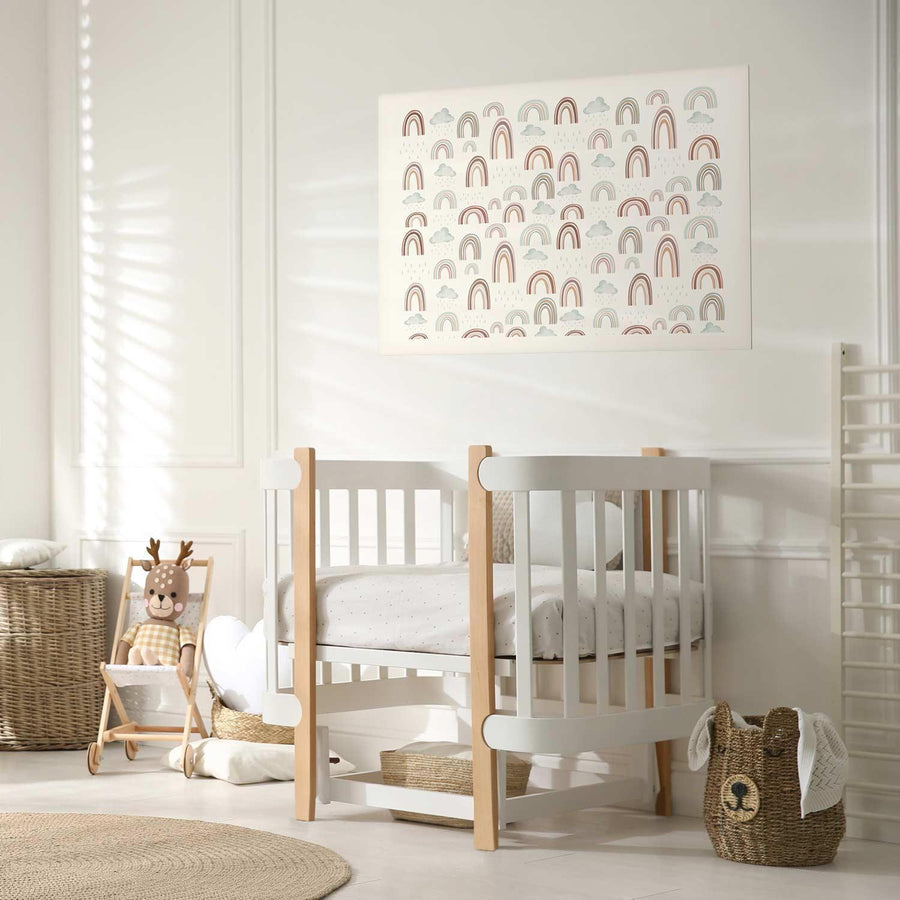 nursery room with crib, rainbow-patterned poster on wall