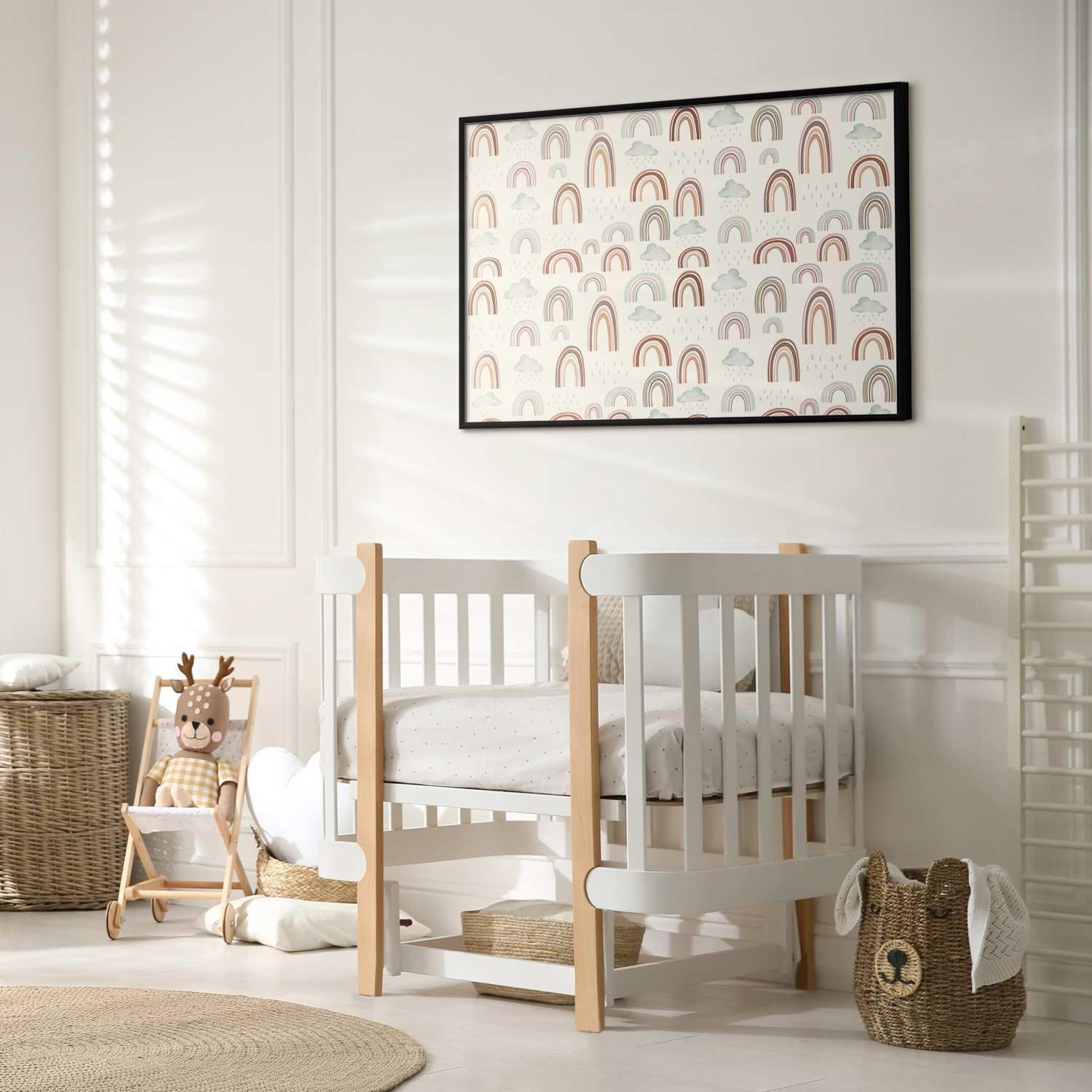 Nursery room with a framed rainbow-themed poster on the wall.