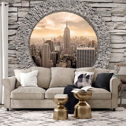 Fototapete Rundes Fenster mit Stadtblick – Urbanes Panorama in Steinoptik