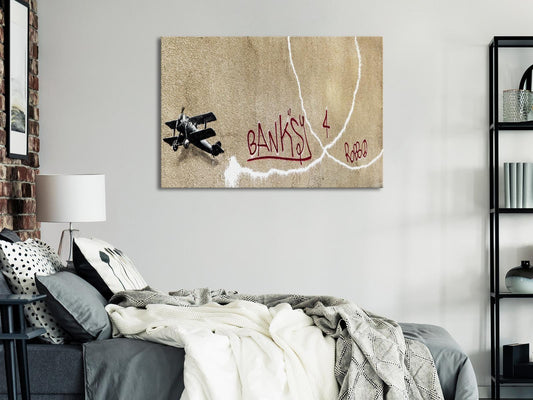 Leinwandbild - Banksy's Plane (1-part) - Red Graffiti Text on Mural Background Artgeist