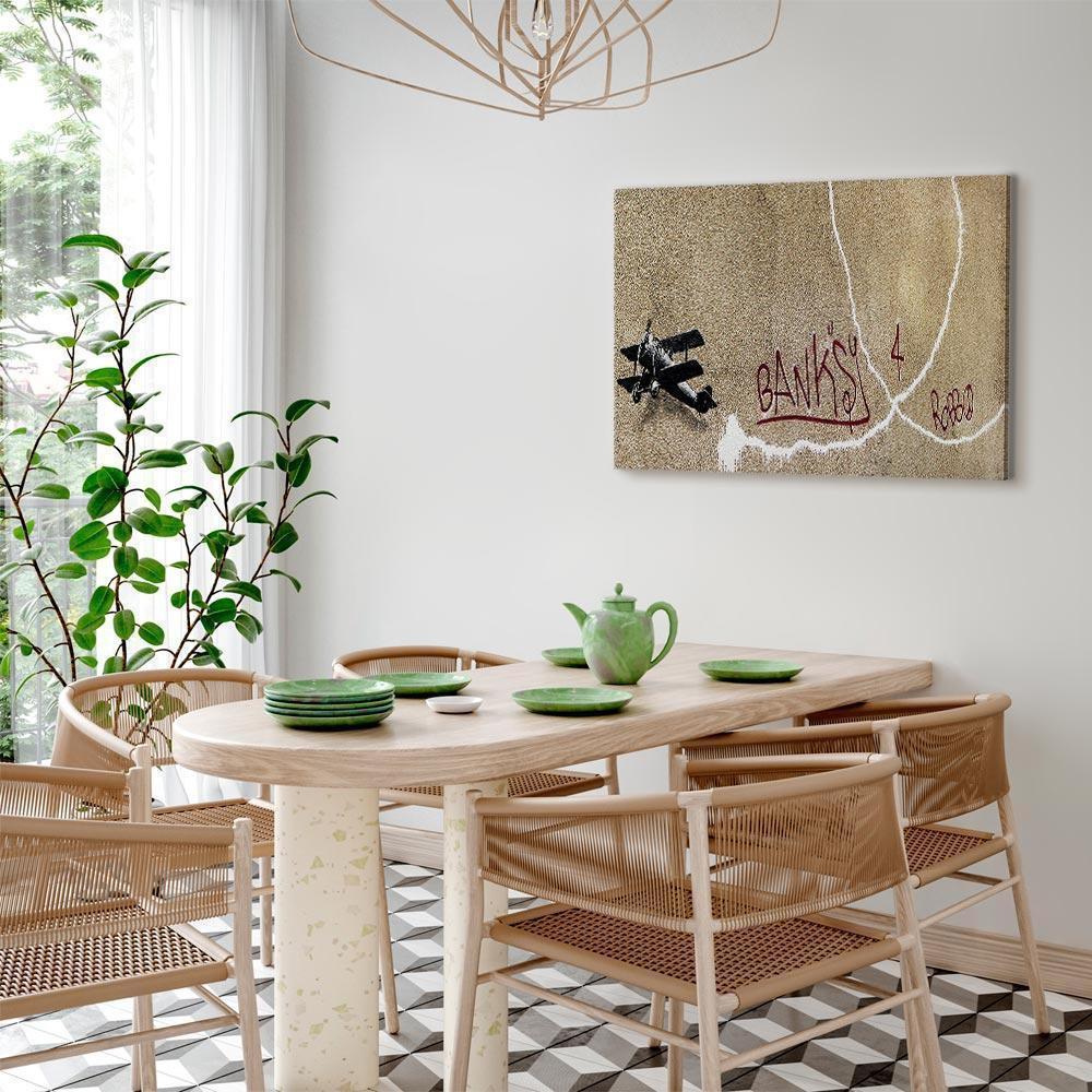 Leinwandbild - Banksy's Plane (1-part) - Red Graffiti Text on Mural Background