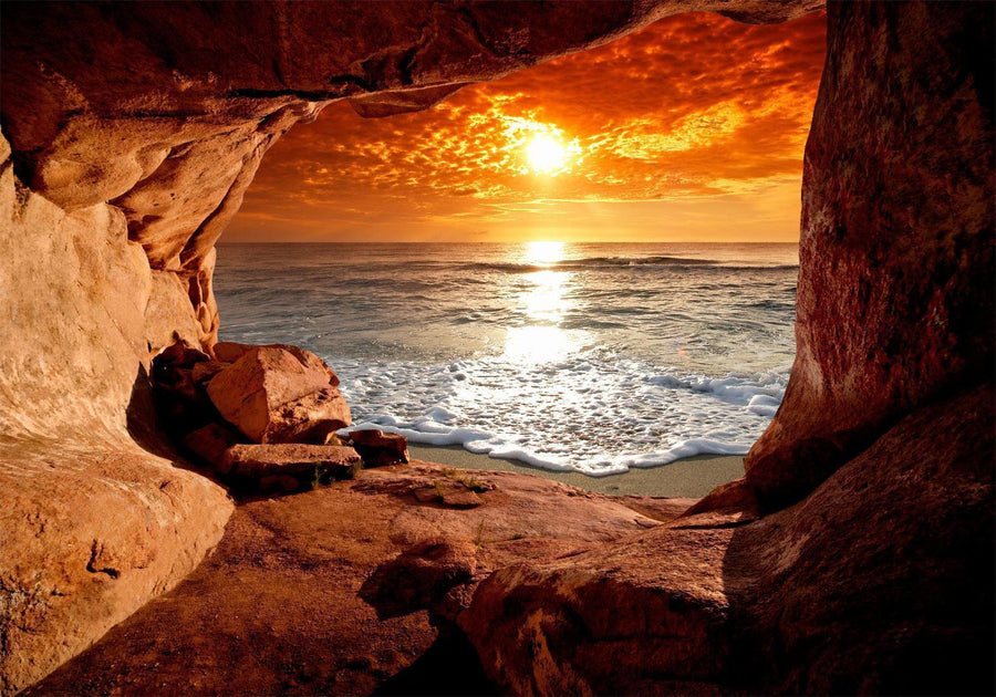 Fototapete „Höhlenausgang mit Blick aufs Meer“ – Sonnenuntergang & Naturkulisse für traumhafte Räume