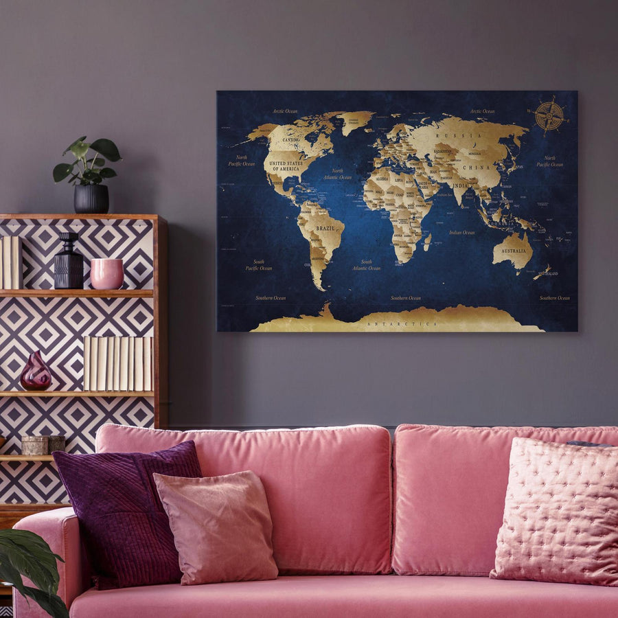 Canvas wall art of a world map with dark blue depths in a stylish living room setting.