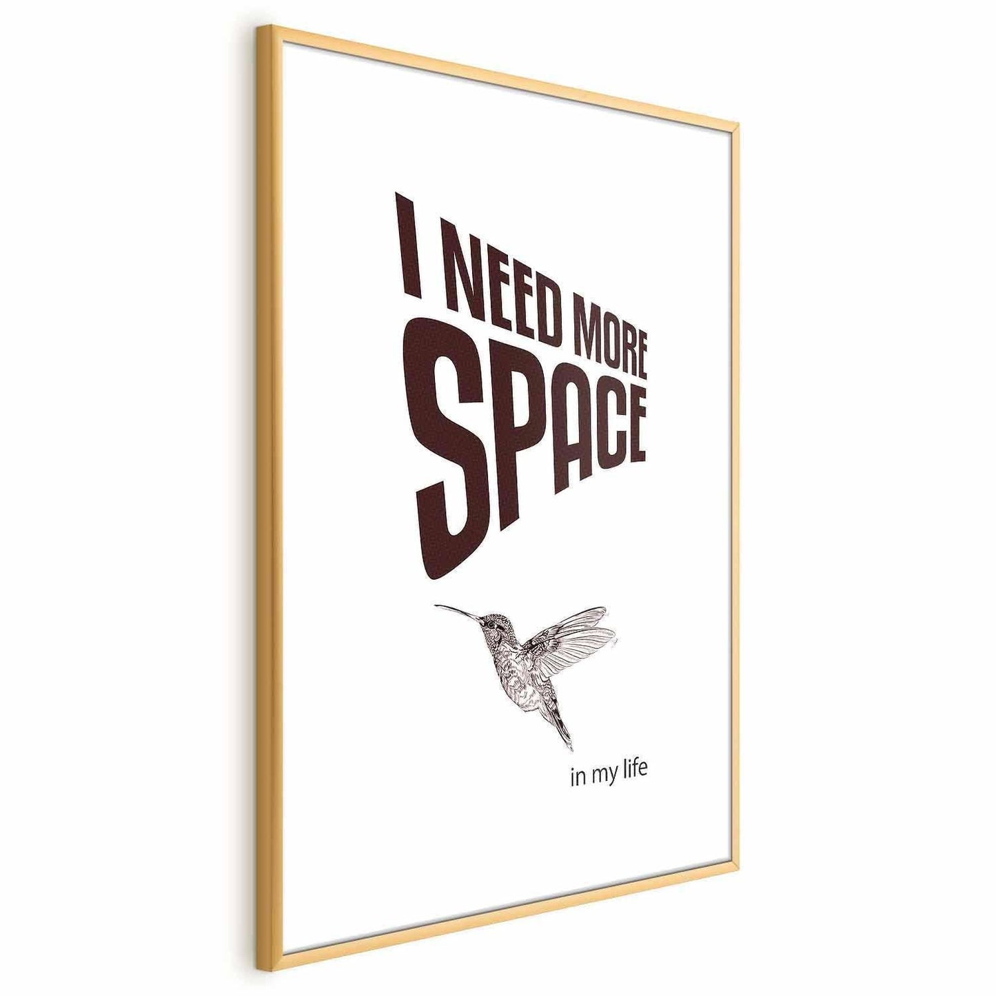 Poster with text "I Need More Space", featuring a minimalist hummingbird illustration, in a stylish gold frame.