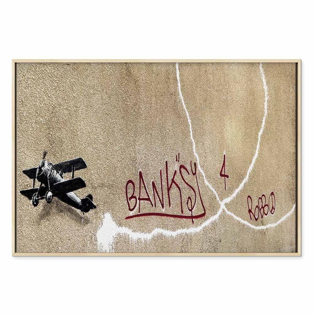 Leinwandbild - Banksy's Plane (1-part) - Red Graffiti Text on Mural Background