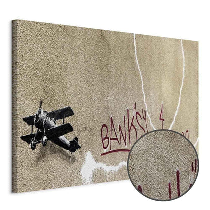 Leinwandbild - Banksy's Plane (1-part) - Red Graffiti Text on Mural Background