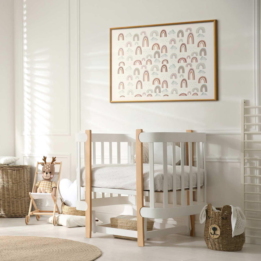 nursery room with framed rainbow poster on wall